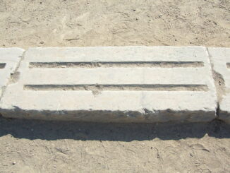 A section of the stone starting line at Olympia, which has a groove for each foot