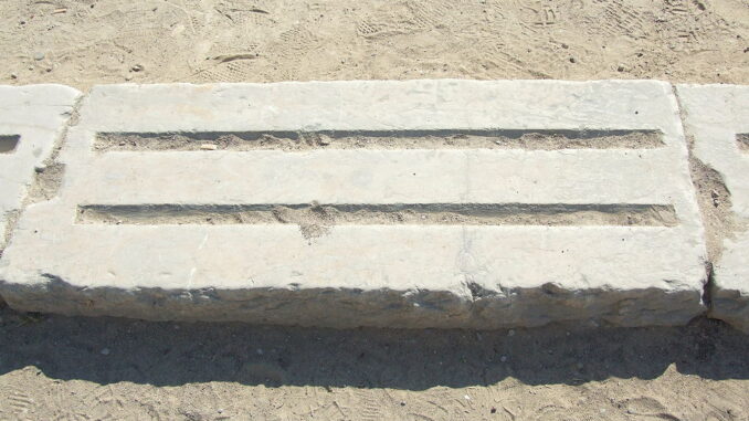 A section of the stone starting line at Olympia, which has a groove for each foot