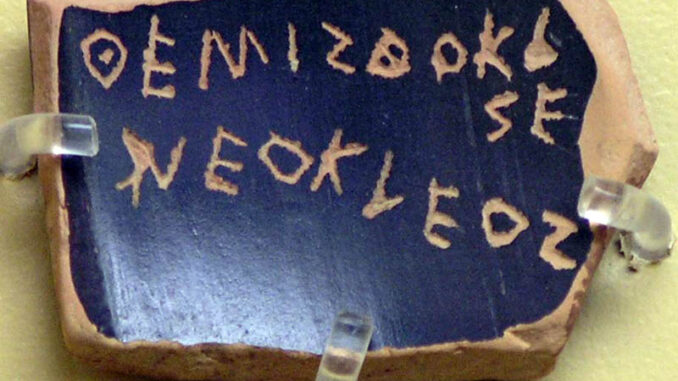 A ballot voting against Themistocles, son of Neocles, under the Athenian Democracy (see ostracism) Inscription: ΘΕΜΙΣΘΟΚΛΕΣ ΝΕΟΚΛΕΟΣ (classical standard Θεμιστοκλῆς Νεοκλέους Themistoklês Neokléous). The text is an example of the epichoric alphabet; note that the last two letters of Themistocles are written in a boustrophedon manner and that Ε and Ο are used for both long and short e and o.